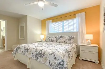 a bedroom with a large bed and a window at Mickeys Paradise - a fabulous 4 bed Paradise Palms Resort pool home that's close to Disney in Kissimmee
