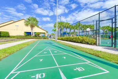 a tennis court with a net on a tennis court at Mickeys Paradise - a fabulous 4 bed Paradise Palms Resort pool home that's close to Disney in Kissimmee