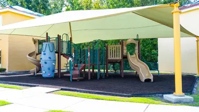 a playground under a tent with a slide at Enchanting Escape 3 Bedroom Minutes from Disney! in Kissimmee
