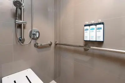 a shower stall in a bathroom with a toilet at Hyatt House Orlando Airport in Orlando