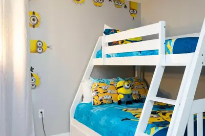 a bedroom with a bunk bed and a white bunk ladder at Amazing Cozy Private Pool - 4404 in Kissimmee