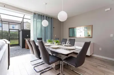 a dining room with a table and chairs at Amazing Cozy Private Pool - 4404 in Kissimmee