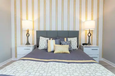 a bedroom with a large bed with two lamps at Amazing Cozy Private Pool - 4404 in Kissimmee
