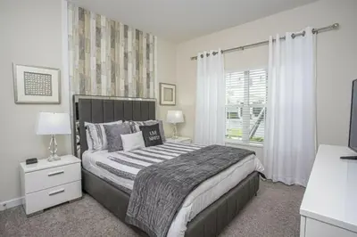 a bedroom with a large bed and a window at Amazing Lovely Private Pool 4844 in Kissimmee