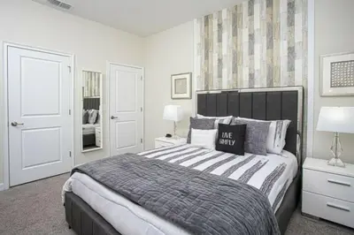 a bedroom with a large bed and two lamps at Amazing Lovely Private Pool 4844 in Kissimmee