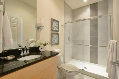a bathroom with a toilet and a sink and a shower at 1523 Cozy Astonishing wPrivate Pool in Orlando
