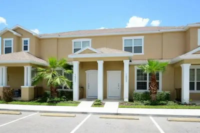 a large house with palm trees in a parking lot at 1523 Cozy Astonishing wPrivate Pool in Orlando