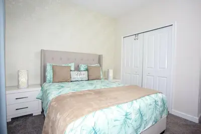 a bedroom with a large bed and a white door at Astonishing Home Private Pool 4830 in Kissimmee