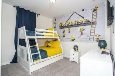 a bedroom with a white bunk bed with yellow accents at Astonishing Home Private Pool 4830 in Kissimmee