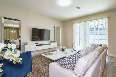 a living room with a couch and a tv at 4712 Fabulous Brand-New Private Pool in Kissimmee