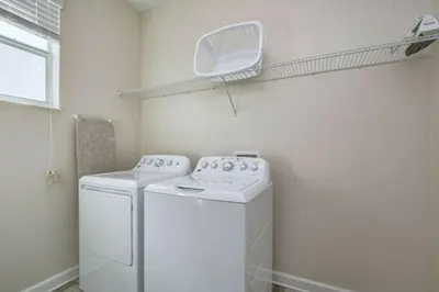 a laundry room with a washer and dryer at 4712 Fabulous Brand-New Private Pool in Kissimmee