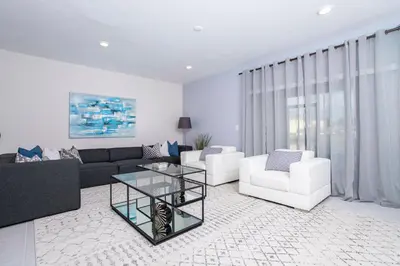 a living room with a couch and a table at 4774 Gorgeous Townhome in Kissimmee