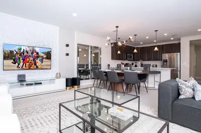 a living room with a couch and a dining room at 4774 Gorgeous Townhome in Kissimmee