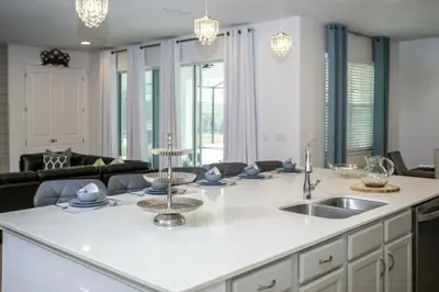 a kitchen and living room with a large kitchen island at 2606YA Luxurious En-Suite Single Home Pool in Kissimmee