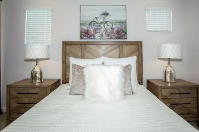 a bedroom with a white bed with two night stands at 2606YA Luxurious En-Suite Single Home Pool in Kissimmee