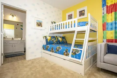 a childs bedroom with bunk beds and a bathroom at 2606YA Luxurious En-Suite Single Home Pool in Kissimmee