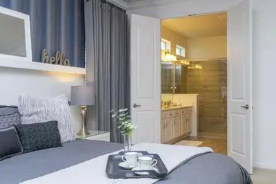 a bedroom with a bed with a tray on it at Luxurious Home Private Pool 2693 in Kissimmee
