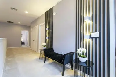 a living room with a black and white striped wall at Luxurious Home Private Pool 2693 in Kissimmee