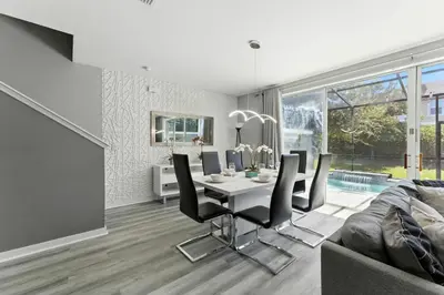 a dining room with a table and chairs at 4412 Luxurious Townhome Private Pool in Kissimmee