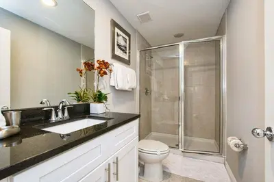 a bathroom with a shower and a sink and a toilet at 4412 Luxurious Townhome Private Pool in Kissimmee