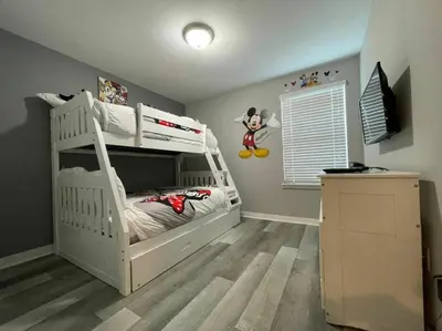 a bedroom with a white bunk bed in a room at 4412 Luxurious Townhome Private Pool in Kissimmee