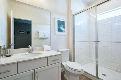 a white bathroom with a toilet and a shower at 2600YA Luxury Gorgeous Private Pool in Kissimmee