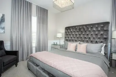 a bedroom with a large bed and a chair at 2620 Magical Memories 15 min-Disney in Orlando