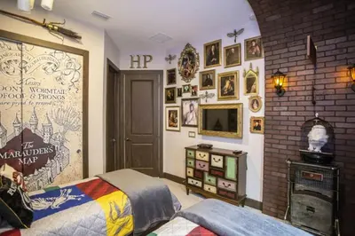 a bedroom with a bed and a wall filled with pictures at 2620 Magical Memories 15 min-Disney in Orlando