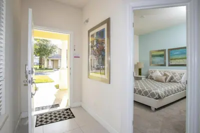a bedroom with a bed and a door leading into a room at 17419 Awesome Modern w Private Pool in Orlando