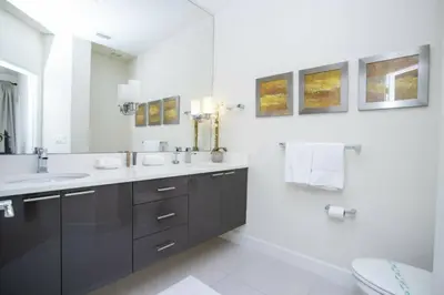 a bathroom with two sinks and a mirror at 17419 Awesome Modern w Private Pool in Orlando