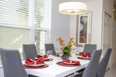 a white dining room with a white table and chairs at 17419 Awesome Modern w Private Pool in Orlando