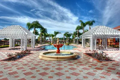 a fountain in a courtyard with two white gazebos at Cozy 3 bedroom home with Private Pool 4564 in Kissimmee