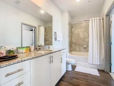 a bathroom with a sink and a toilet and a tub at Your Dream Apartment Stay in Kissimmee