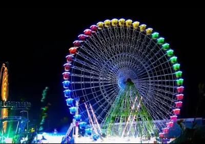 a large ferris wheel at a carnival at night at Hidden City Riverfront Apt Near Lakes Golf & Disney in Kissimmee