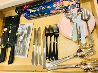 a group of utensils on a table with forks and spoons at Hidden City Riverfront Apt Near Lakes Golf & Disney in Kissimmee