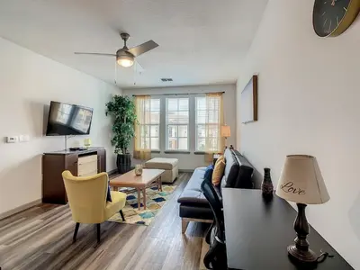 a living room with a couch and a table at Large Apartment, Close To Disney in Kissimmee