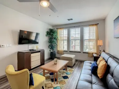 a living room with a couch and a tv at Large Apartment, Close To Disney in Kissimmee