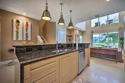 a large kitchen with a sink and a counter at Upscale Townhome Close to Walt Disney World! in Orlando