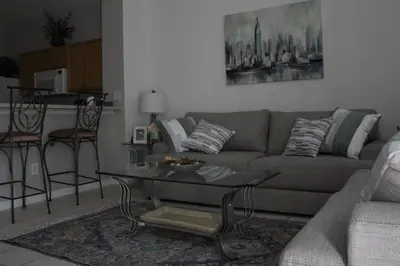 a living room with a couch and a table at Veteran Owned 3bdr/3 bath Townhouse w/WiFi 3mi to Disney - Fall/Winter Specials in Kissimmee