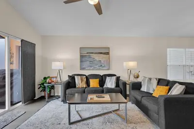 a living room with two couches and a table at Disney Getaway Villa in Kissimmee