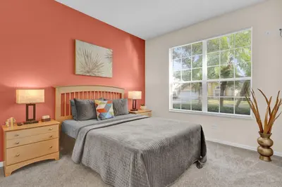 a bedroom with a bed and a window at Disney Getaway Villa in Kissimmee