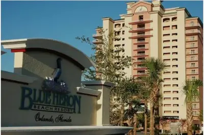 a building with a sign in front of a building at Lake view condo close to Disney in Orlando