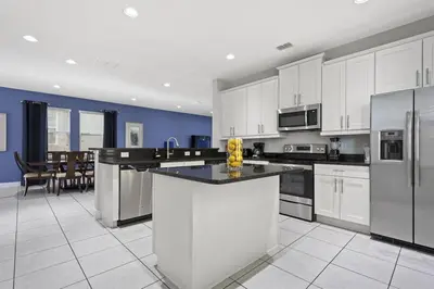 a large kitchen with white cabinets and appliances at 350-360 Huge Villas - near Disney - 15 BDs in Orlando