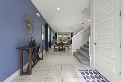 a hallway with a white door and a table at 350-360 Huge Villas - near Disney - 15 BDs in Orlando