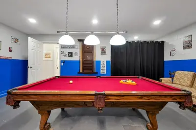 a pool table in a room with a red cloth at Walkin' on Sunshine - 5 bed pool home in Terra Verde Resort near Disney in Kissimmee
