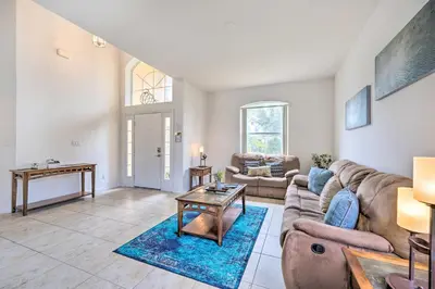 a living room with a couch and a table at Dog-Friendly Kissimmee Home with Lanai and Pool! in Kissimmee