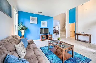 a living room with a couch and a table at Dog-Friendly Kissimmee Home with Lanai and Pool! in Kissimmee