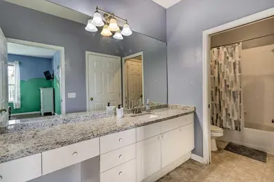 a bathroom with two sinks and a large mirror at 6 Mi to Disney World Condo with Community Perks! in Kissimmee
