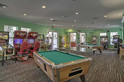 a room with several arcade games and a pool table at 6 Mi to Disney World Condo with Community Perks! in Kissimmee