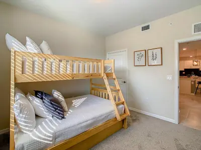 a bedroom with a bunk bed with pillows at Homely Lakeview 3BR Condo with Waterpark in Kissimmee